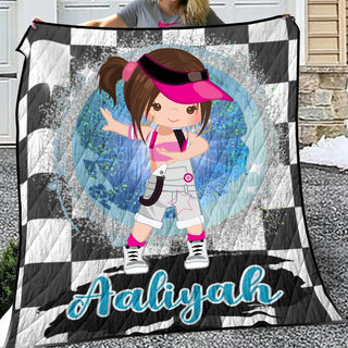 a girl holding a quilt with a picture of a girl on it