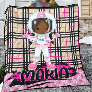 a woman holding up a blanket with a picture of an astronaut on it