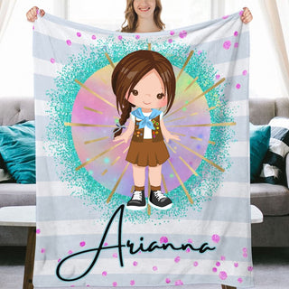 a girl holding up a personalized blanket