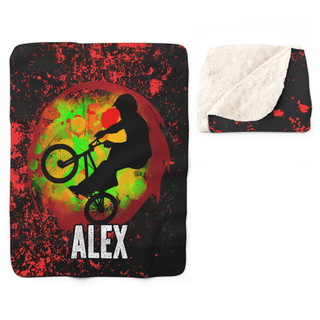 a blanket with a picture of a man riding a bike