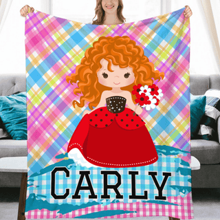 a woman holding up a personalized blanket