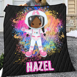 a woman holding a blanket with an image of a girl in a space suit