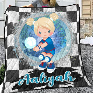 a girl holding a soccer ball on a checkered blanket