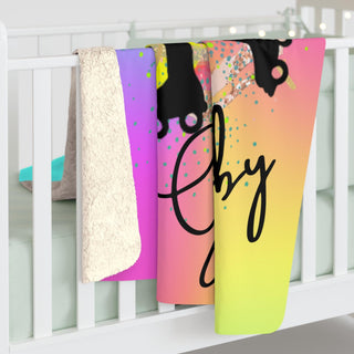 a crib with three towels hanging on the side of it