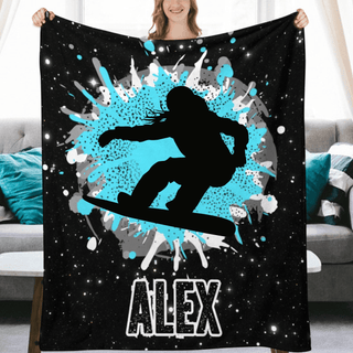 a woman holding up a blanket with a picture of a skateboarder on it