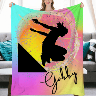 a woman holding a colorful blanket with a picture of a skateboarder