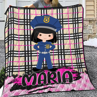 a girl holding up a blanket with a picture of a police officer on it