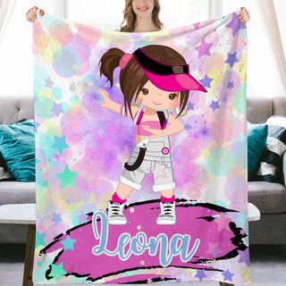 a girl holding up a personalized blanket