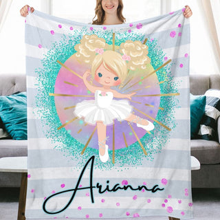 a girl holding a personalized blanket with a picture of a ballerina