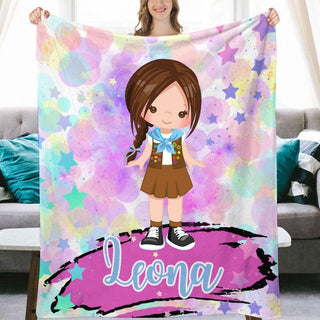 a girl holding up a personalized blanket