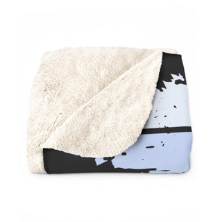 a blanket with a black and white design on it