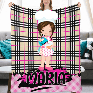 a woman holding a pink and black blanket with a picture of a girl on it