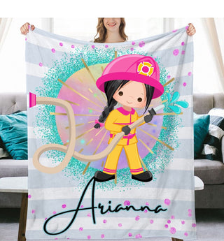 a girl holding a personalized firefighter blanket