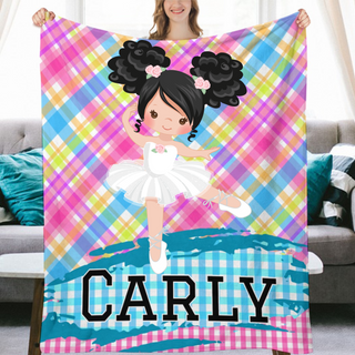 a girl holding a personalized blanket with a picture of a ballerina