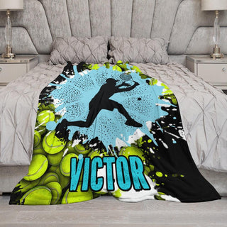 a bed covered in a blanket with a picture of a tennis player