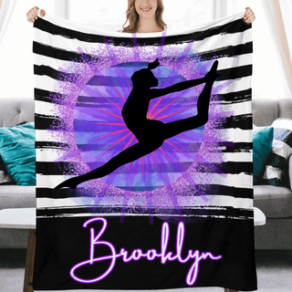 a woman holding up a purple and black blanket