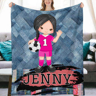 a girl holding a soccer ball in front of a quilt