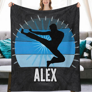 a woman holding up a blanket that says alex