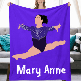 a woman holding up a purple blanket with a picture of a woman on it