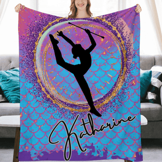 a woman holding up a purple and blue blanket