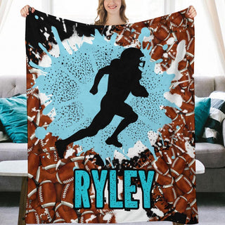 a woman holding up a blanket with a picture of a football player on it