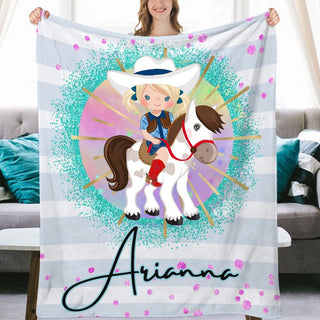 a woman holding up a personalized blanket with a picture of a girl on a