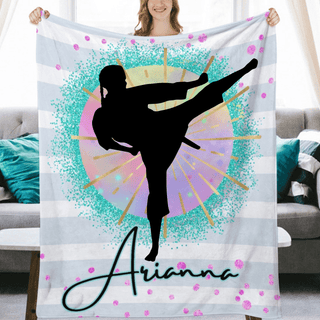 a woman holding up a personalized blanket