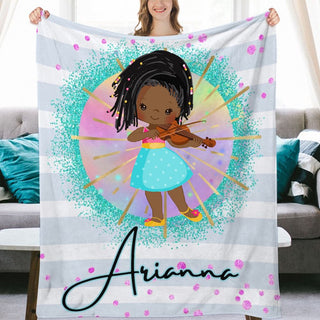 a woman holding a personalized blanket with a picture of a girl holding a violin