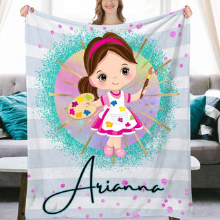 a girl holding a personalized blanket in front of a couch