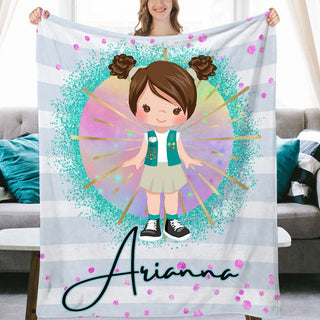 a girl holding up a personalized blanket