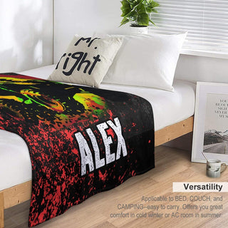 a bed with a black and red blanket on top of it