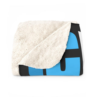 a blue and black blanket on a white background