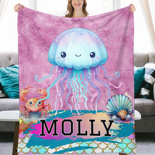 a woman holding a blanket with a picture of a jellyfish