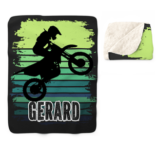 a blanket with a picture of a man riding a dirt bike