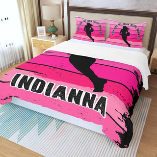 a bed with a pink and black bed spread