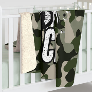 a baby crib with a blanket hanging from it's side