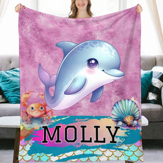 a woman holding a blanket with a dolphin on it