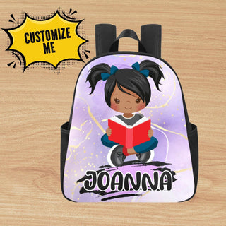 a backpack with a picture of a girl reading a book