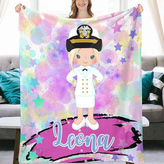 a woman holding up a personalized blanket