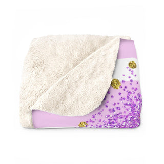 a white and purple blanket with a purple and gold design