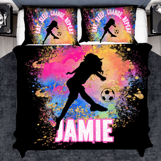 a girl kicking a soccer ball on a bed