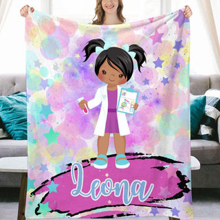 a girl holding up a personalized blanket