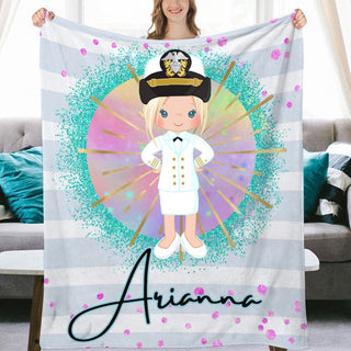 a woman holding up a personalized blanket