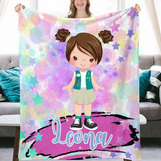 a girl holding up a personalized blanket