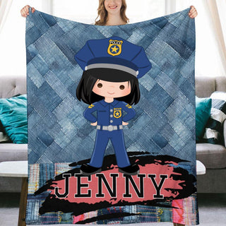 a woman holding up a blanket with a picture of a police officer on it