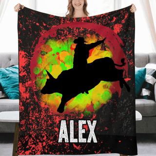 a woman holding a blanket with a picture of a cowboy riding a bull