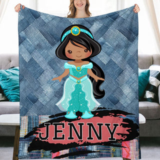 a girl holding up a blanket with a picture of a princess on it