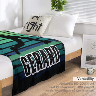 a bed with a black and green blanket on top of it