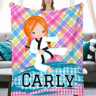 a woman holding a personalized blanket in front of a couch