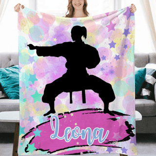 a woman holding a personalized blanket in front of a couch